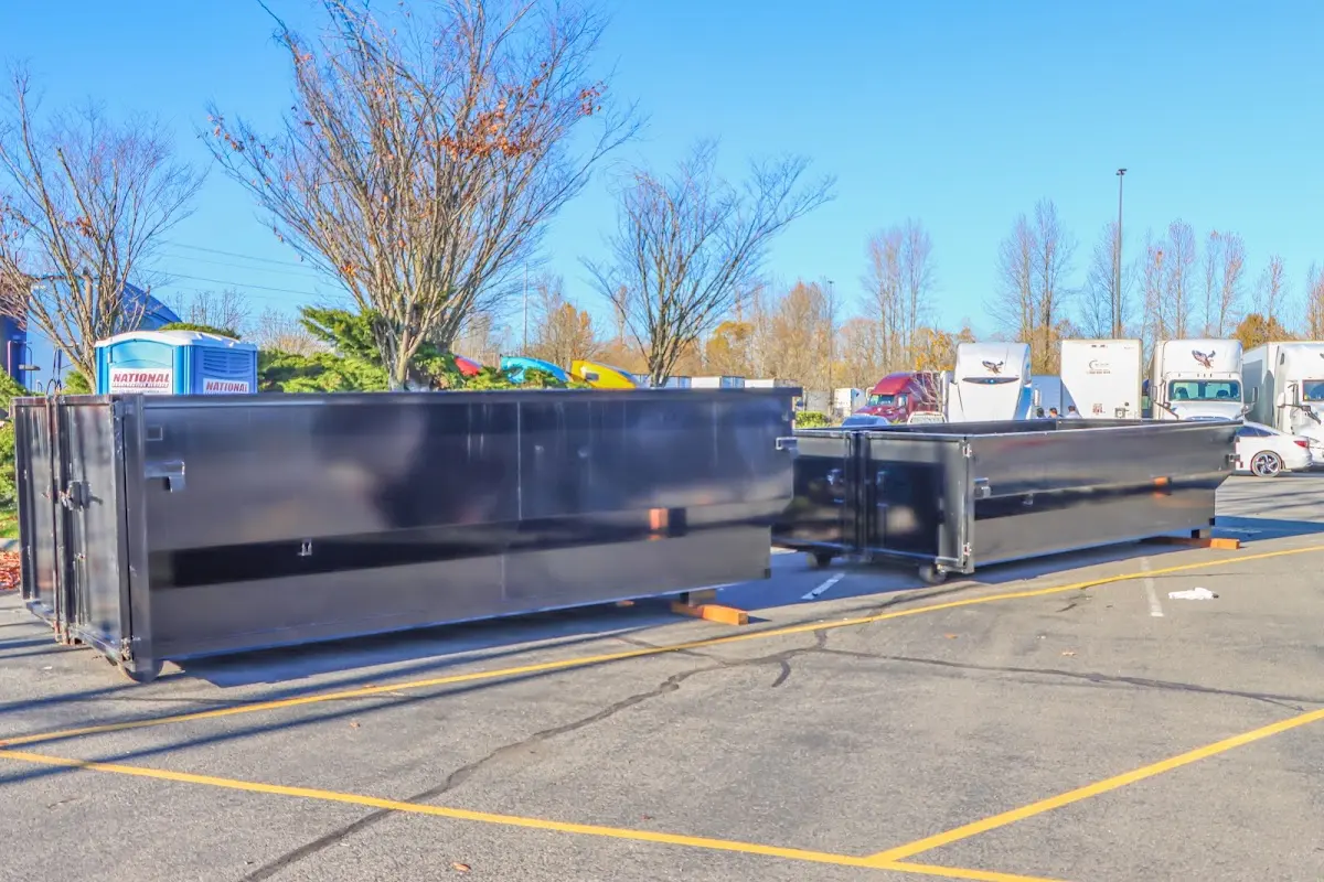 Professional dumpster rental service with roll-off container on residential driveway in Tittabawassee